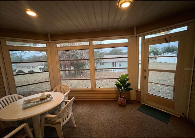 sunroom with a wealth of natural light and wood ceiling