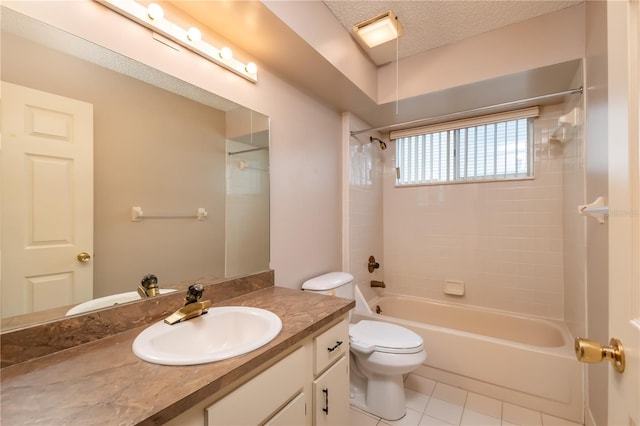 full bathroom featuring toilet, tiled shower / bath, tile patterned flooring, vanity, and a textured ceiling