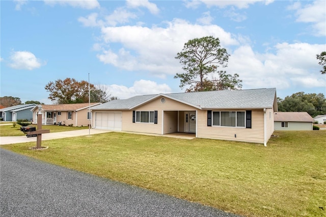 ranch-style home featuring a front lawn and a garage