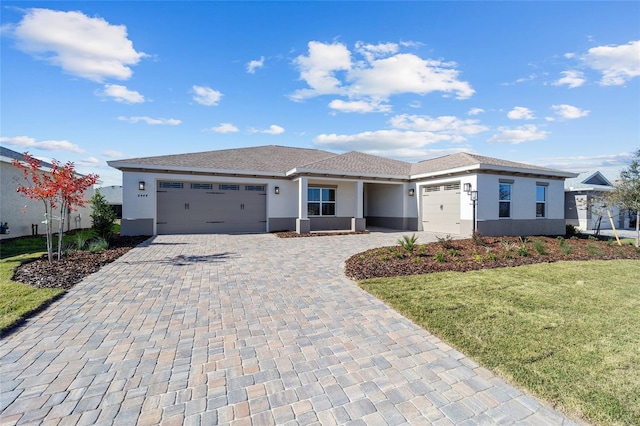 view of front of home featuring a garage and a front lawn