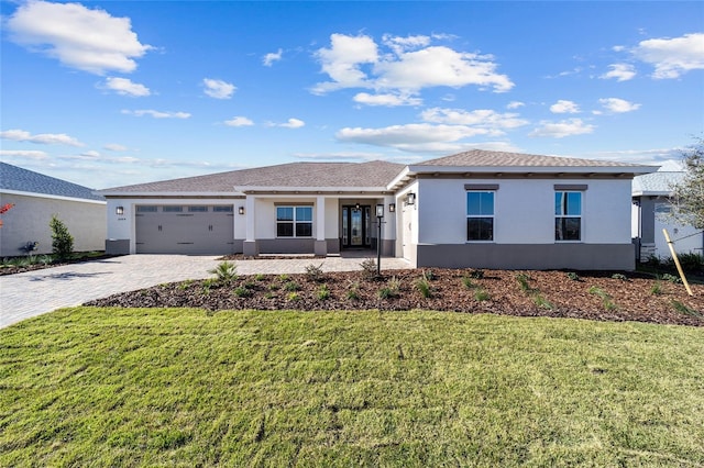 view of front of property with a garage and a front lawn