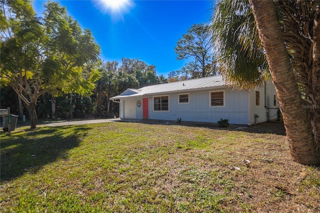 back of property featuring a yard