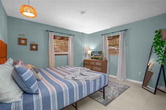 bedroom with multiple windows and a textured ceiling