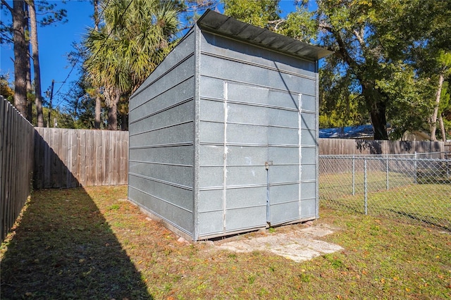 view of outbuilding featuring a yard