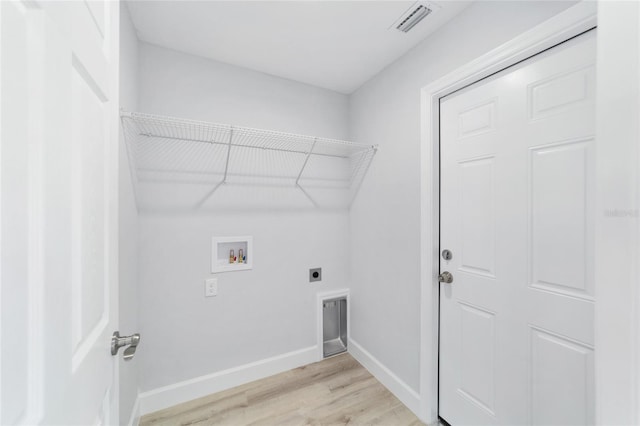 washroom featuring hookup for an electric dryer, hookup for a washing machine, and light wood-type flooring