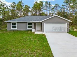 ranch-style house featuring a garage and a front yard