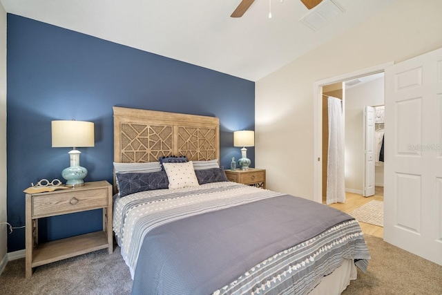 carpeted bedroom with vaulted ceiling and ceiling fan