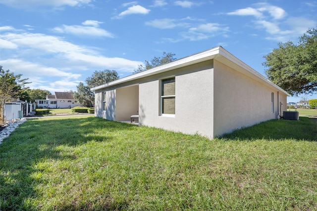 view of property exterior with cooling unit and a lawn