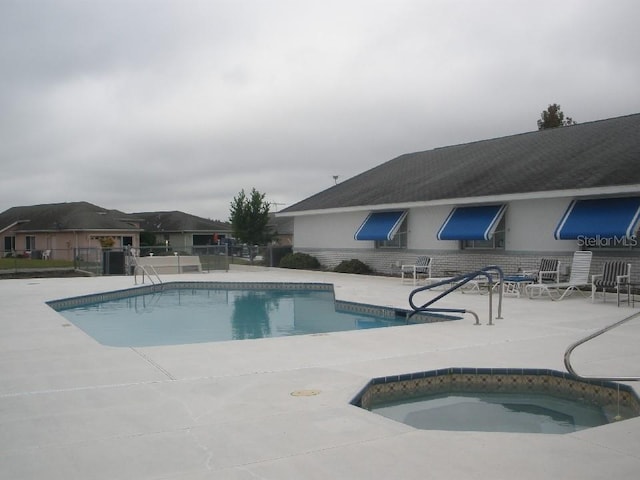 view of pool featuring a patio area and a community hot tub