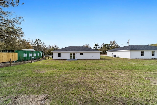 back of property with a lawn