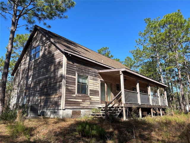 exterior space featuring covered porch and cooling unit