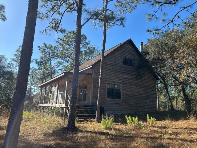 view of side of property with a porch