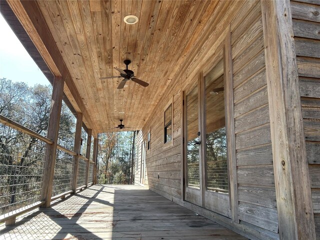 wooden deck featuring ceiling fan