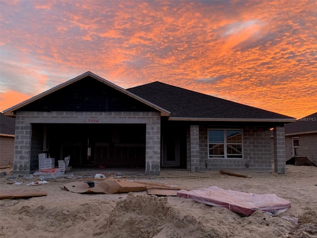 336 W Rexford Dr, Beverly Hills, FL 34465 - view of front facade with concrete block siding, a garage, and roof with shingles