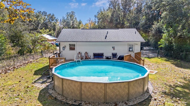 view of pool featuring a yard and a wooden deck