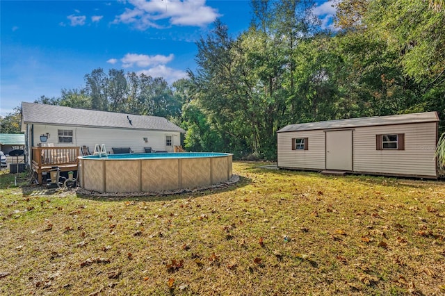 view of yard featuring a pool side deck and a storage shed