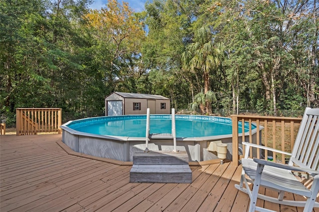 view of pool featuring a wooden deck and a storage shed