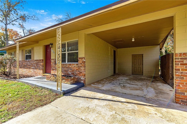 doorway to property featuring a carport