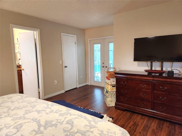 bedroom featuring access to exterior, dark hardwood / wood-style flooring, a textured ceiling, and french doors