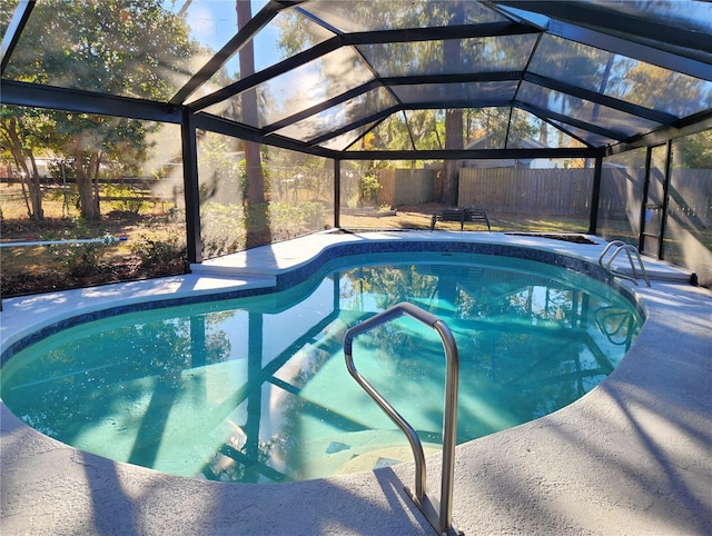 view of swimming pool featuring a lanai