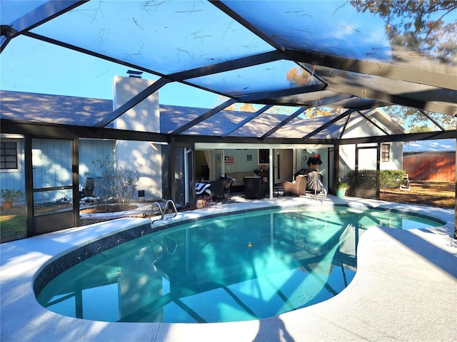 view of swimming pool with a patio and a lanai