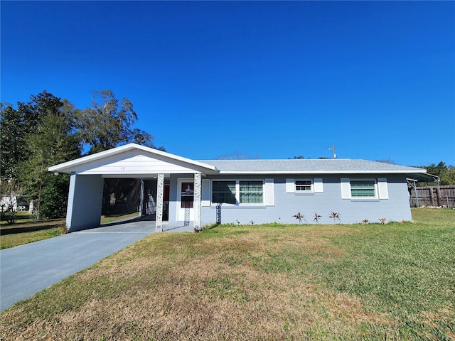 ranch-style home with a front yard and a carport