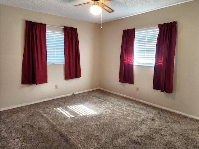 carpeted empty room featuring a textured ceiling and ceiling fan