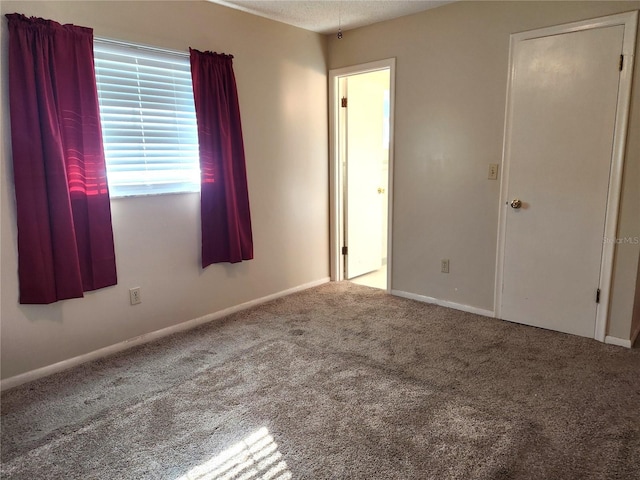 unfurnished room featuring carpet flooring