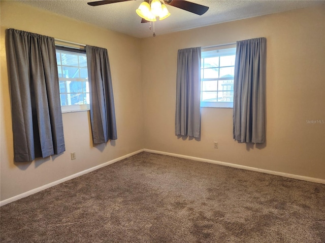 spare room featuring ceiling fan, carpet, and a textured ceiling