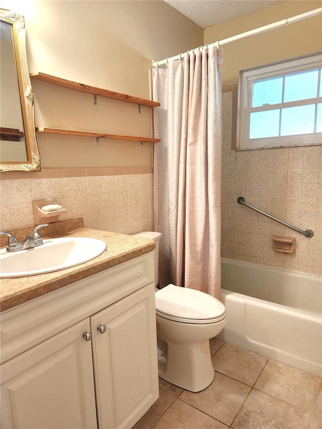 full bathroom featuring shower / bath combination with curtain, vanity, tile walls, tile patterned flooring, and toilet