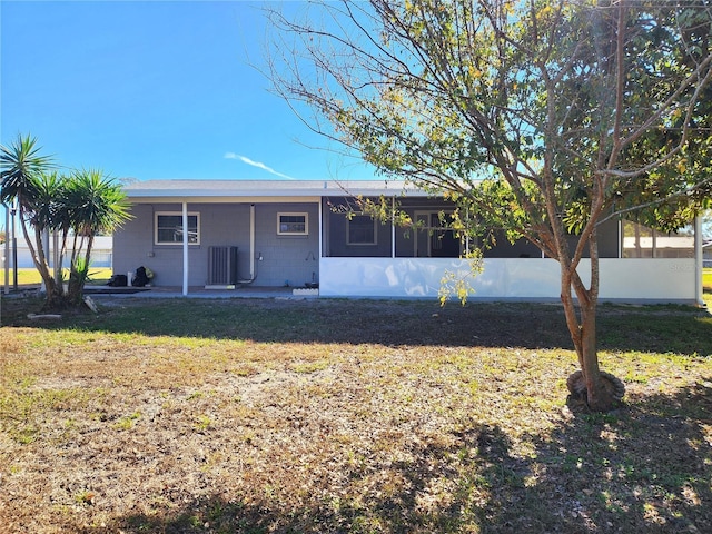 view of front of property featuring central AC and a front lawn