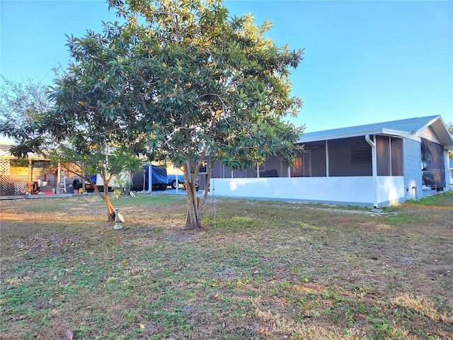 view of yard featuring a sunroom