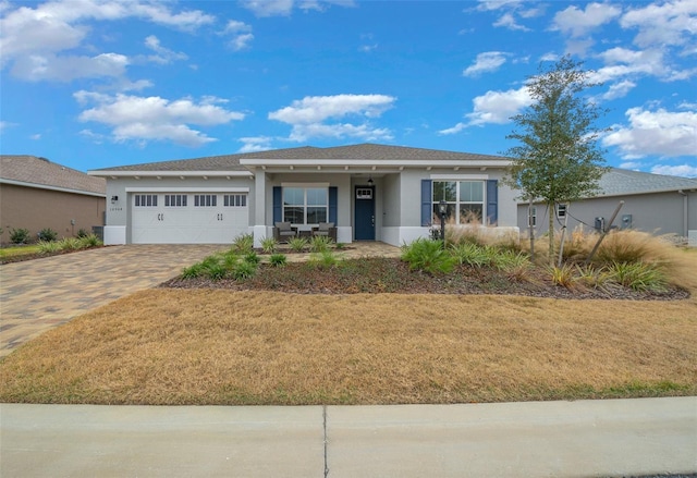 10564 SW 98th Ln, Ocala, FL 34481 - single story home featuring stucco siding, a garage, driveway, covered porch, and a front lawn