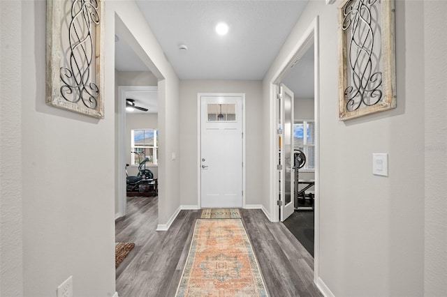 interior space featuring a textured ceiling and dark wood-type flooring