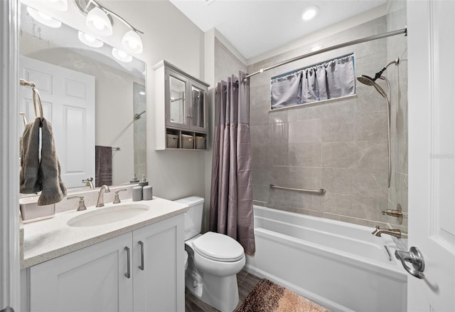 full bathroom with vanity, hardwood / wood-style flooring, toilet, and shower / bathtub combination with curtain