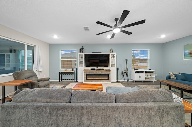 10564 SW 98th Ln, Ocala, FL 34481 - living area with ceiling fan, a glass covered fireplace, wood finished floors, and recessed lighting