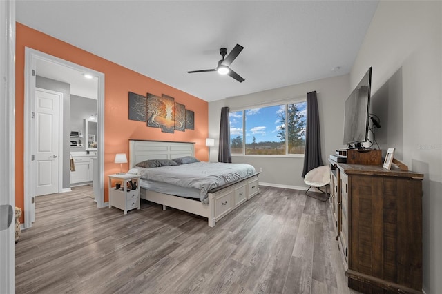 bedroom with ensuite bath, light hardwood / wood-style flooring, and ceiling fan