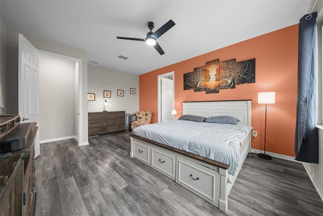 bedroom with ceiling fan and dark hardwood / wood-style flooring