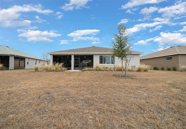 10564 SW 98th Ln, Ocala, FL 34481 - rear view of house featuring a sunroom and a lawn