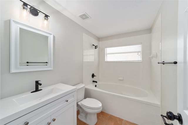 full bathroom with tiled shower / bath, vanity, tile patterned floors, and toilet