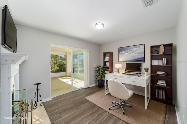 home office featuring a fireplace and dark hardwood / wood-style flooring