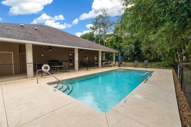 view of swimming pool with a patio area and ceiling fan