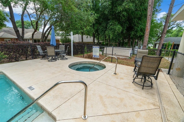 view of swimming pool featuring a patio and a community hot tub