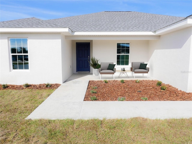 doorway to property with a lawn