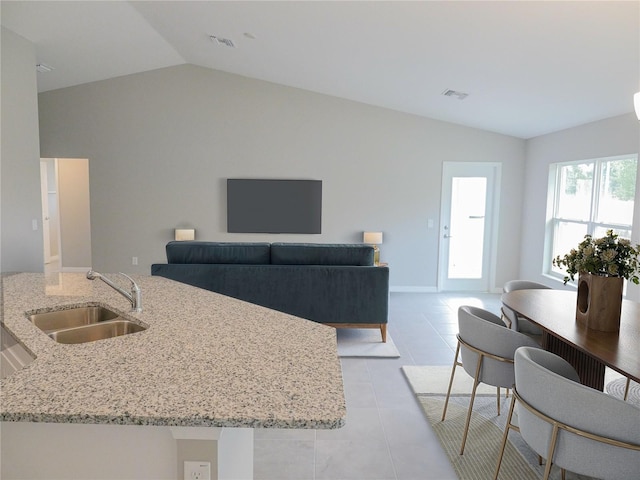 tiled living room featuring lofted ceiling and sink