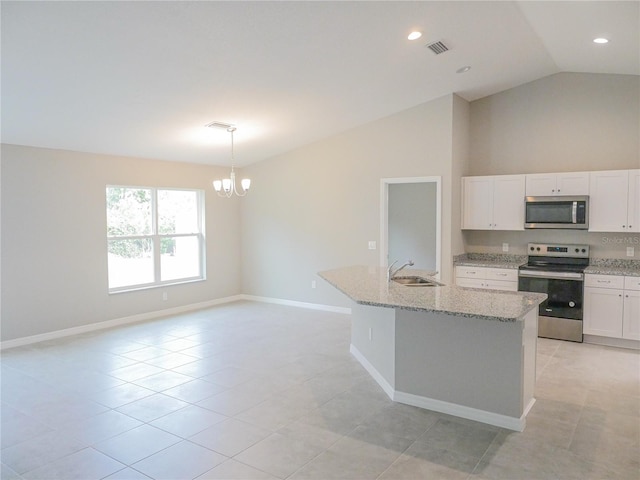 kitchen with sink, decorative light fixtures, an island with sink, stainless steel appliances, and light stone countertops