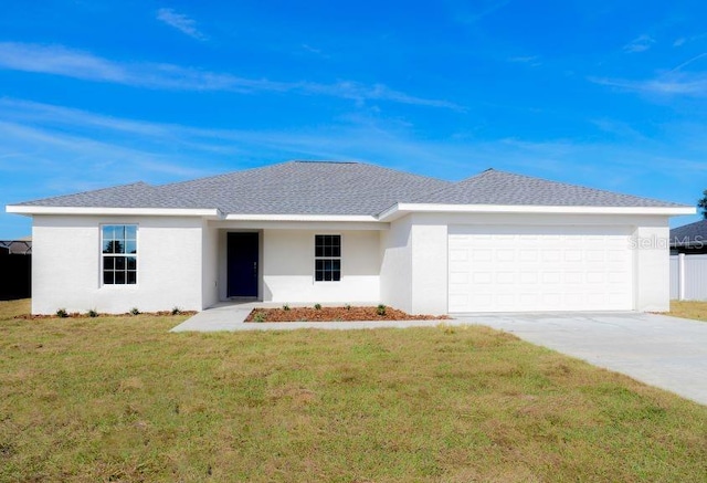 ranch-style home featuring a garage and a front yard