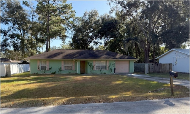 ranch-style home featuring a front yard and a garage