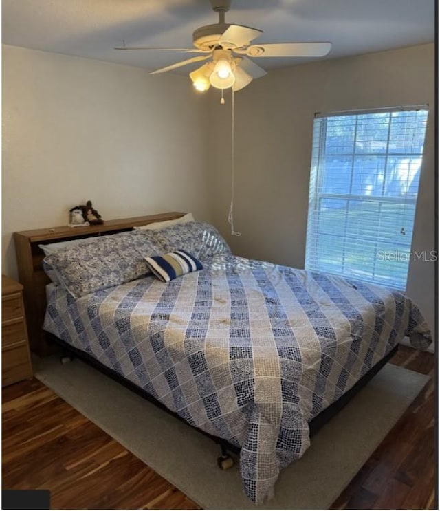 bedroom featuring ceiling fan and dark hardwood / wood-style floors