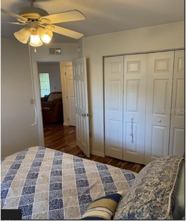 bedroom with ceiling fan, dark hardwood / wood-style flooring, and a closet